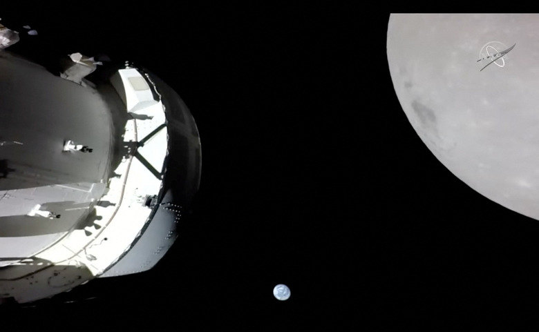 A camera on Orion's solar array wing captures a view of the spacecraft, the Earth and the Moon during the spacecraft's outbound powered flyby of the Moon as part of the Artemis I mission November 21, 2022 in a still image from video. Artemis I, the first flight test of NASA's Orion capsule and Space Launch System rocket, launched November 16, 2022, and is scheduled to splashdown December 11. NASA TV/Handout via REUTERS THIS IMAGE HAS BEEN SUPPLIED BY A THIRD PARTY.