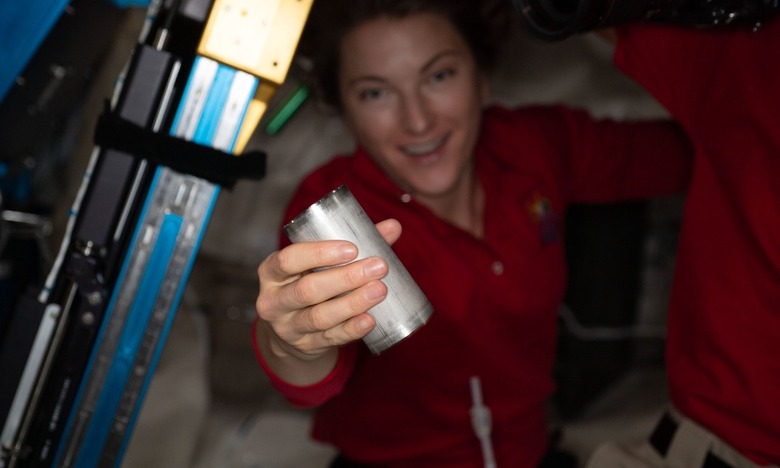 NASA astronaut Kayla Barron replaces a filter in the space station’s Brine Processor Assembly.