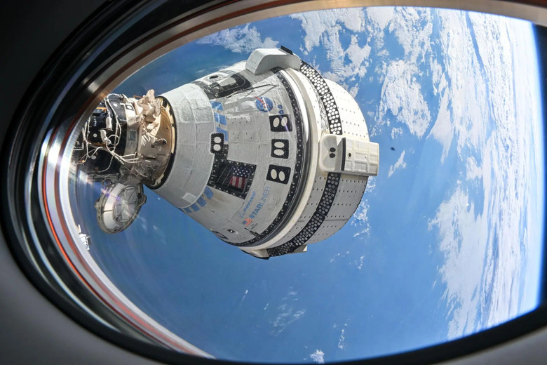 A space capsule with the Earth in the background.