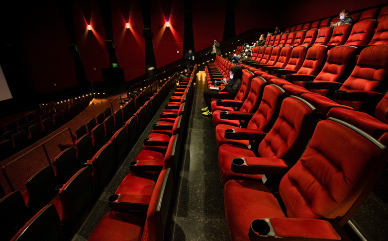 Patrons sit in a nearly empty AMC theatre while they wait for the first screening on reopening day during the outbreak of the coronavirus disease (COVID-19), in Burbank, California, U.S., March 15, 2021.  REUTERS/Mario Anzuoni