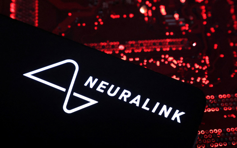 A smartphone with a Neuralink logo displayed is placed on a computer motherboard in this illustration taken on May 15, 2024. REUTERS/Dado Ruvic/Illustration