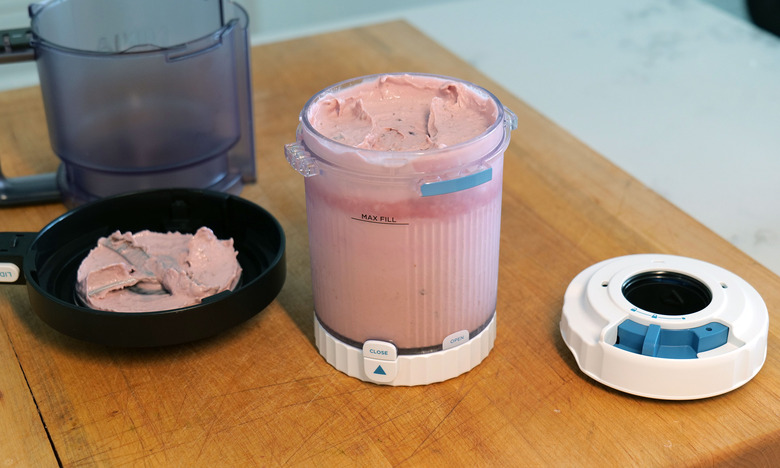 If you want to make soft serve, after using the standard paddle lid (left) to spin your ice cream base, you'll need to attach Ninja's dedicated soft serve lid (right) before slotting the entire pint into the opening on the left side of the machine.
