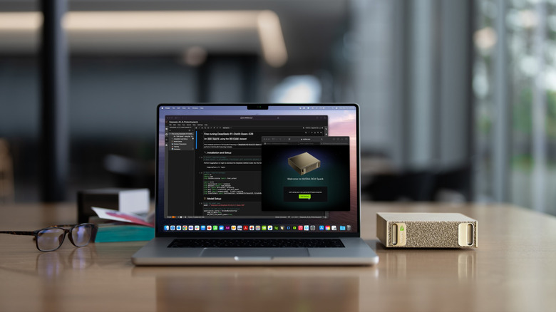 A DGX Spark workstation sits next to a MacBook Pro.