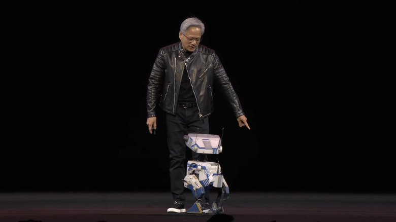 Huang on stage with Blue, the robot.