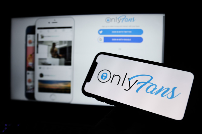 OnlyFans logo displayed on a phone screen and a website in the background are seen in this illustration photo taken in Krakow, Poland on April 27, 2021. (Photo Illustration by Jakub Porzycki/NurPhoto via Getty Images)