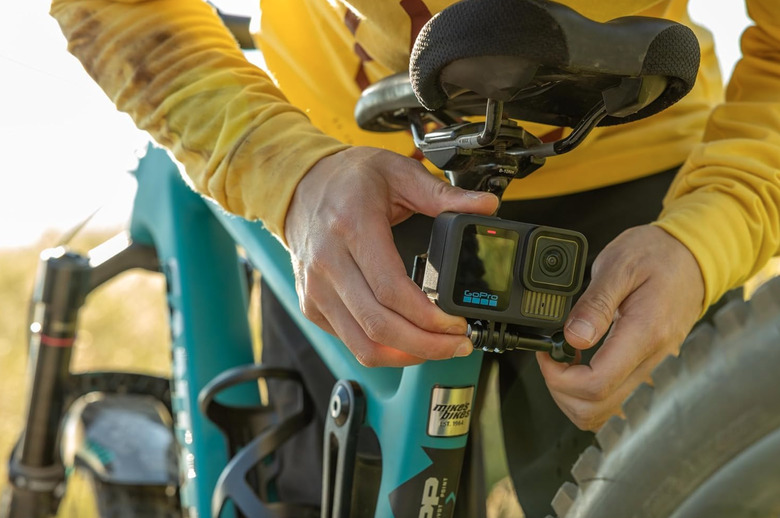 A camera behind held by someone who could use a shower.