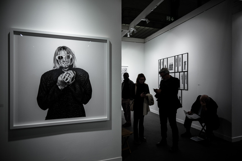 Visitors stand next to a photograph of late US singer Kurt Cobain by Dutch photographer Anton Corbijn during the opening of the 20th edition of Paris photo, the international fine art photography fair at the Grand Palais in Paris on November 9, 2016. 
The fair runs from November 10 to 13, 2016.   / AFP / PHILIPPE LOPEZ / RESTRICTED TO EDITORIAL USE - MANDATORY MENTION OF THE ARTIST UPON PUBLICATION - TO ILLUSTRATE THE EVENT AS SPECIFIED IN THE CAPTION        (Photo credit should read PHILIPPE LOPEZ/AFP/Getty Images)