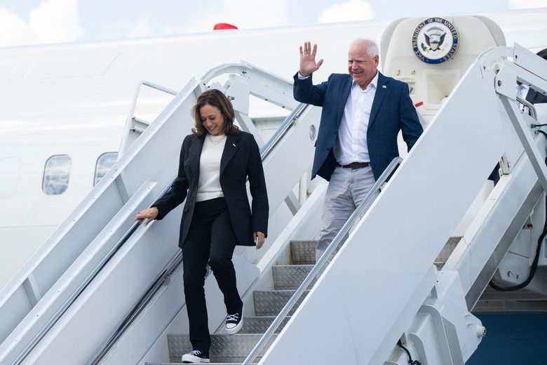 (L-R) US Vice President and Democratic presidential candidate Kamala Harris and her running mate Minnesota Governor Tim Walz step off Air Force Two upon arrival at Savannah/Hilton Head International Airport in Savannah, Georgia, August 28, 2024, as they travel for a 2-day campaign bus tour. (Photo by SAUL LOEB / AFP) (Photo by SAUL LOEB/AFP via Getty Images)