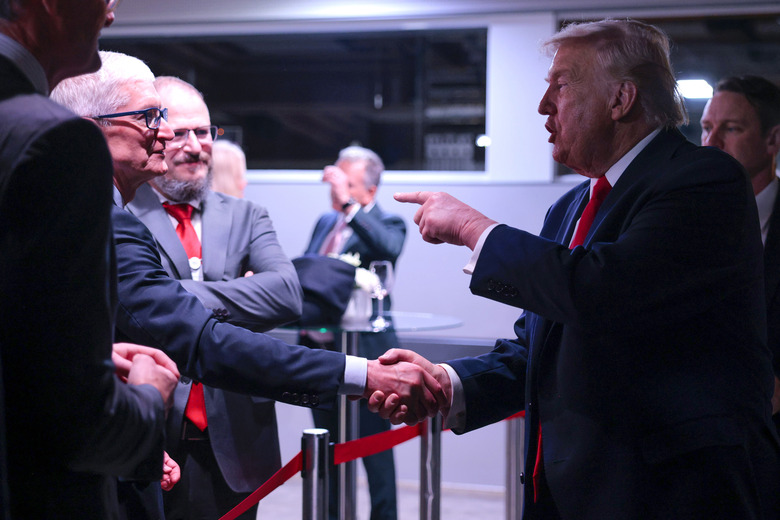 DAVOS, SWITZERLAND - JANUARY 21: U.S. President Donald Trump (R) speaks to Apple CEO Tim Cook (L) as he attends a reception for business leaders (Photo by Chip Somodevilla/Getty Images)