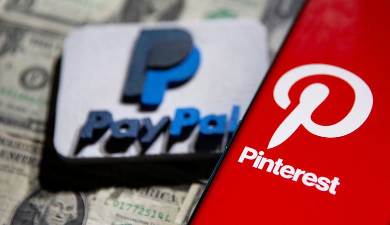 A Pinterest logo is seen on a smartphone placed over U.S. dollar banknotes and a 3D printed PayPal logo in this illustration taken October 20, 2021. REUTERS/Dado Ruvic/Illustration