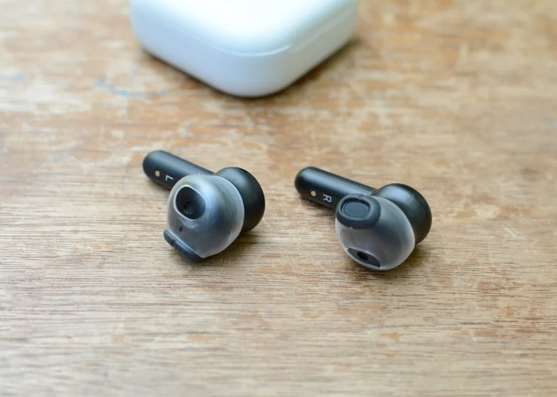 Some earbuds on a table.