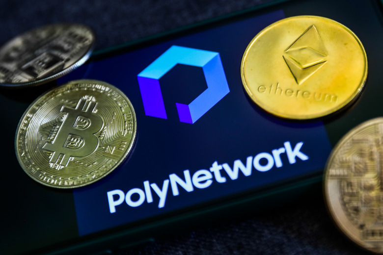 Poly Network logo displayed on a phone screen and representation of cryptocurrencies are seen in this illustration photo taken in Sulkowice, Poland on August 12, 2021. (Photo by Jakub Porzycki/NurPhoto via Getty Images)