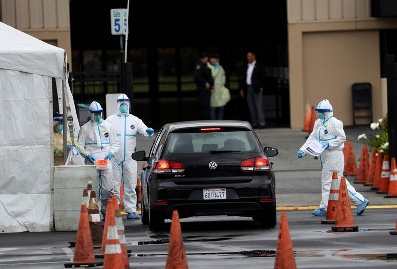 Employees at Verily administering drive-thru tests.