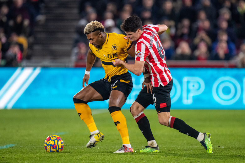 BRENTFORD, ENGLAND - JANUARY 22: Adama Traore of Wolverhampton Wanderers and Christian Norgaard of Brentford in action during the Premier League match between Brentford and Wolverhampton Wanderers at Brentford Community Stadium on January 22, 2022 in Brentford, United Kingdom. (Photo by Sebastian Frej/MB Media/Getty Images)