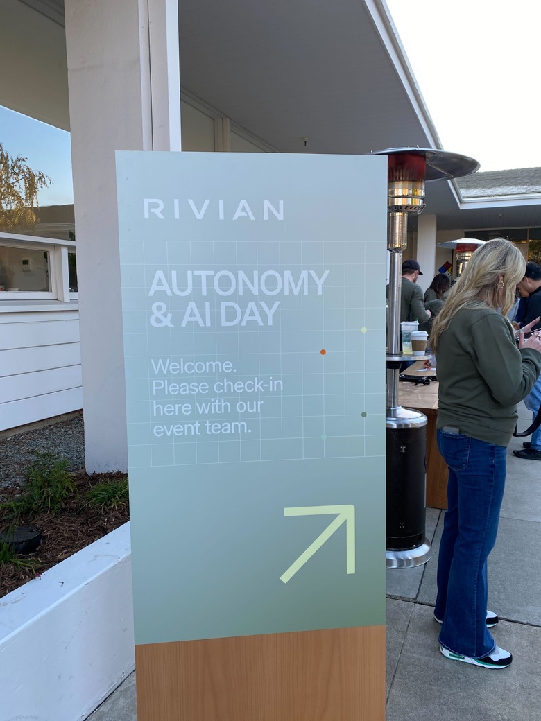A sign with the Rivian logo and the words 