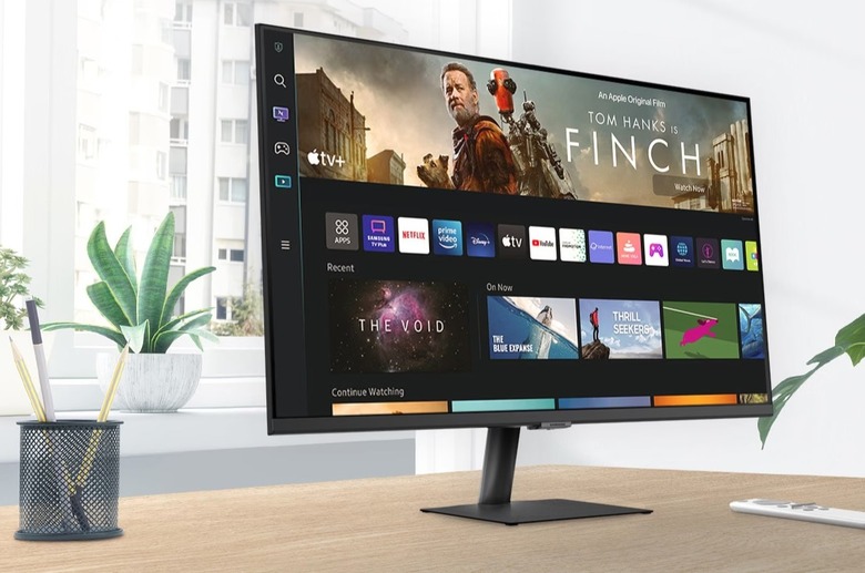 Samsung M70B Smart Monitor on a desk next to a pen holder and a remote.