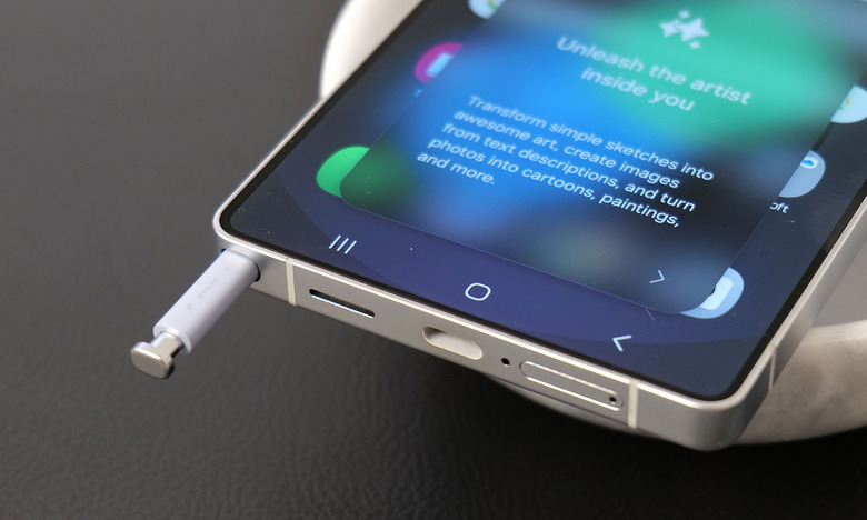 An S Pen sticking out of its slot on the bottom left corner of a Galaxy S25 Ultra.