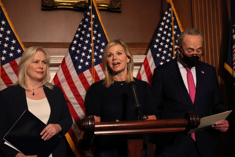 Former Fox News Anchor, Gretchen Carlson speaks to reporters with U.S. Senator Kirsten Gillibrand (D-NY) and Senate Majority Leader Chuck Schumer (D-NY) following the passage of the bill, known as the Ending Forced Arbitration of Sexual Assault and Sexual Harassment Act on Capitol Hill in Washington, U.S., February 10, 2022.  REUTERS/Brendan McDermid