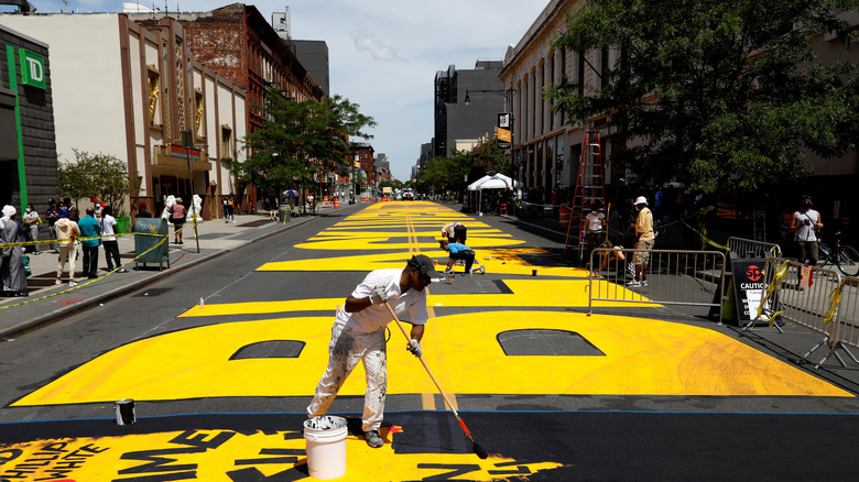Volunteers work on a 'Black Lives Matter' mural on the street as a protest against racial inequality in the aftermath of the death in Minneapolis police custody of George Floyd, in Brooklyn, New York, U.S., June 16, 2020. REUTERS/Brendan McDermid TPX IMAGES OF THE DAY