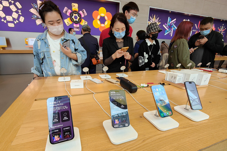 SHANGHAI, CHINA - NOVEMBER 11, 2022 - Customers select and try out iPhone14 series at an Apple store in Shanghai, China, Nov 11, 2022. In many countries, including the UK, Japan, Germany and Australia, the price of Apple's iPhone 14 series of smartphones has risen sharply, with only Chinese and US consumers marginally affected. Specifically, the starting price of the iPhone 14 rose by about $90 in the United Kingdom, about $34 in Australia and about $100 in Germany. The premium model, the iPhone 14 Pro Max, is about $170 more expensive in the UK than when it was released last year. (Photo credit should read CFOTO/Future Publishing via Getty Images)