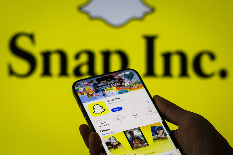 CHONGQING, CHINA - OCTOBER 27: The Snapchat app page is displayed on a smartphone in the Apple App Store in front of the Snap Inc. logo on October 27, 2024 in Chongqing, China. (Photo by Cheng Xin/Getty Images)