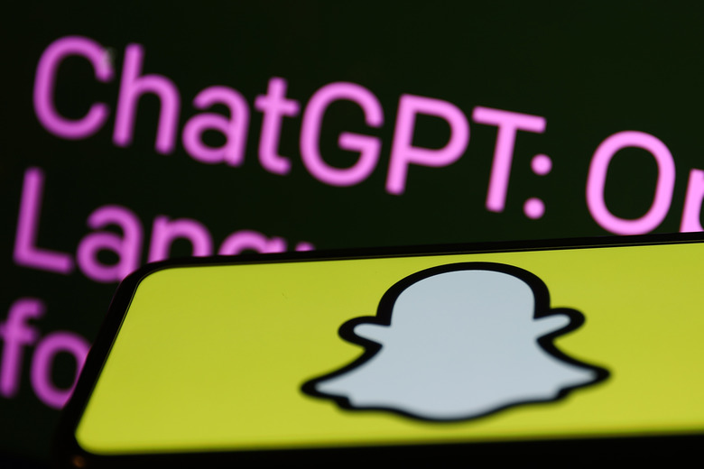 OpenAI ChatGPT website displayed on a laptop screen and Snapchat logo displayed on a phone screen are seen in this illustration photo taken in Krakow, Poland on February 27, 2023. (Photo by Jakub Porzycki/NurPhoto via Getty Images)
