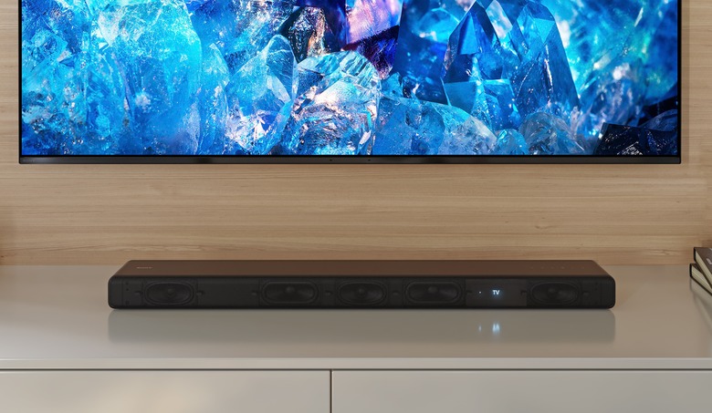 Sony's HT-A3000 soundbar, positioned on a white surface below a wall-hung TV.