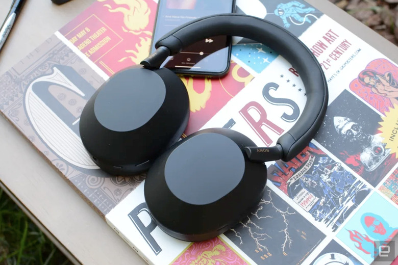 Some headphones on top of an art book.