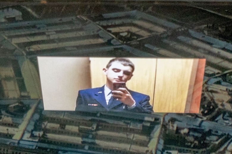 This photo illustration created on April 13, 2023, shows the suspect, national guardsman Jack Teixeira, reflected in an image of the Pentagon in Washington, DC. - FBI agents on Thursday arrested a young national guardsman suspected of being behind a major leak of sensitive US government secrets -- including about the Ukraine war. US Attorney General Merrick Garland announced the arrest made 