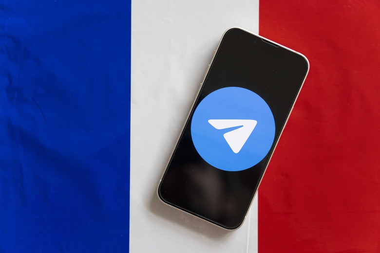 JAPAN - 2024/08/27: In this photo illustration, a Telegram logo seen displayed on a smartphone with the French flag in the background. Russian born Pavel Durov, CEO of the instant messaging app Telegram was arrested in France on August 26, 2024. (Photo Illustration by Stanislav Kogiku/SOPA Images/LightRocket via Getty Images)