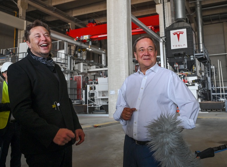 North Rhine-Westphalia's State Premier, Christian Democratic Union (CDU) leader and candidate for Chancellor Armin Laschet (R) and US entrepreneur and business magnate Elon Musk visit the future foundry of the Tesla Gigafactory plant under construction, on August 13, 2021 in Gruenheide near Berlin, eastern Germany. (Photo by Patrick Pleul / POOL / AFP) (Photo by PATRICK PLEUL/POOL/AFP via Getty Images)