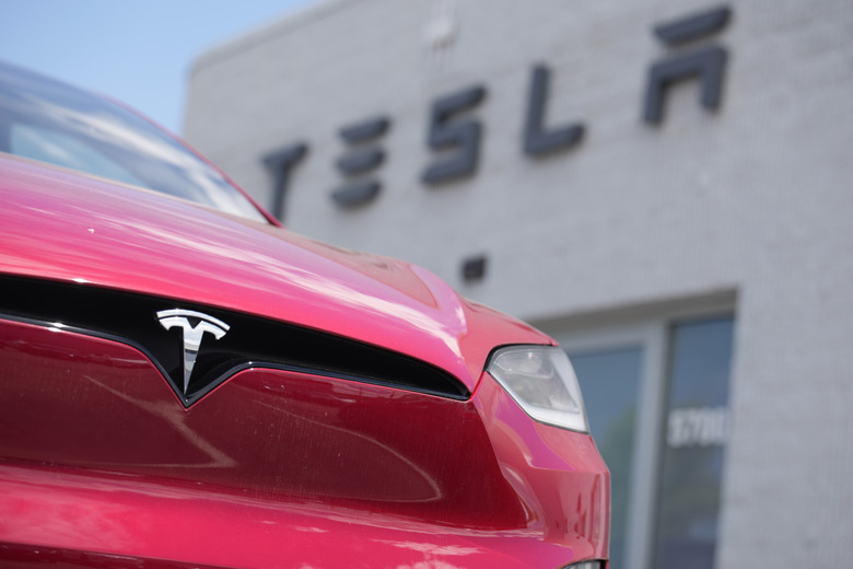 FILE - A Model X sports-utility vehicle sits outside a Tesla store in Littleton, Colo., June 18, 2023. (AP Photo/David Zalubowski, File)