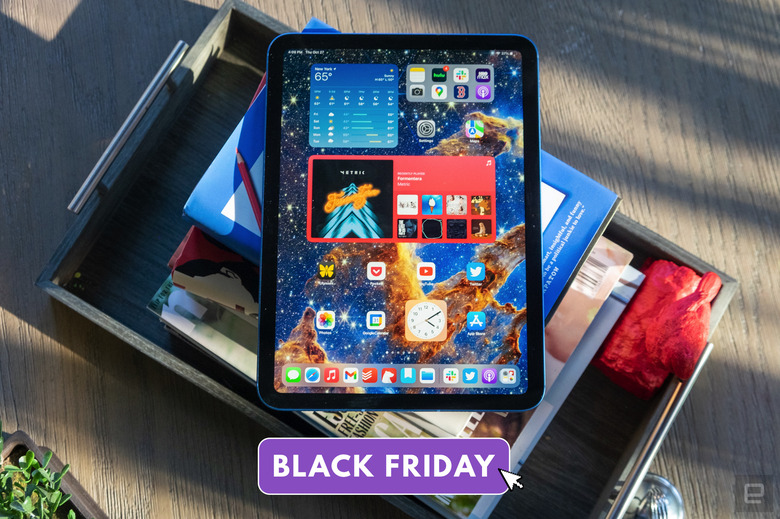 An iPad site on top of a pile of books. Text superimposed on the bottom of the image reads 