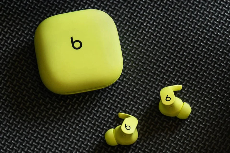 Beats Fit Pro in Volt Yellow on a dark textured background