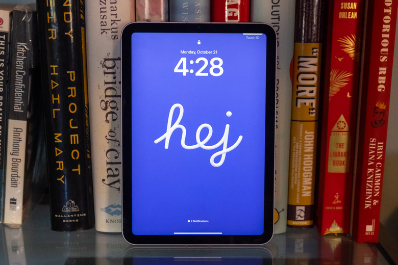 The 2024 ipad mini on a book case with books in the background