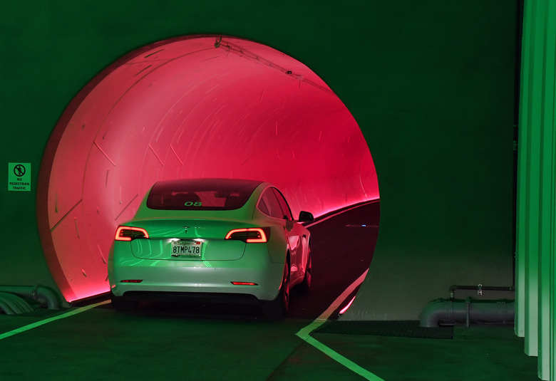 LAS VEGAS, NEVADA - APRIL 09:  A Tesla car drives through a tunnel in the Central Station during a media preview of the Las Vegas Convention Center Loop on April 9, 2021 in Las Vegas, Nevada. The Las Vegas Convention Center Loop is an underground transportation system that is the first commercial project by Elon Musk’s The Boring Company. The USD 52.5 million loop, which includes two one-way vehicle tunnels 40 feet beneath the ground and three passenger stations, will take convention attendees across the 200-acre convention campus for free in all-electric Tesla vehicles in under two minutes. To walk that distance can take upward of 25 minutes. The system is designed to carry 4,400 people per hour using a fleet of 62 vehicles at maximum capacity. It is scheduled to be fully operational in June when the facility plans to host its first large-scale convention since the COVID-19 shutdown. There are plans to expand the system throughout the resort corridor in the future.  (Photo by Ethan Miller/Getty Images)