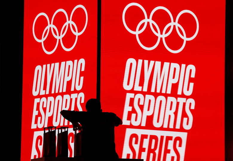 A crew member arranges trophies to be awarded at the Olympic Esports Week in Singapore June 23, 2023. REUTERS/Edgar Su