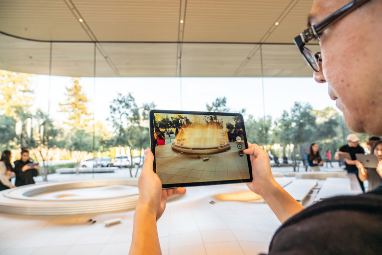 CUPERTINO, UNITED STATES - 2020/02/23: A customer using an iPad for an augmented reality (AR) tour to see a virtual version of the Apple Park campus at the Apple Park Visitor Center in Cupertino. (Photo by Alex Tai/SOPA Images/LightRocket via Getty Images)