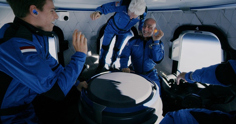 Image of Mark Bezos, Wally Funk and Oliver Daemen while in zero-g in Blue Origin's first flight.