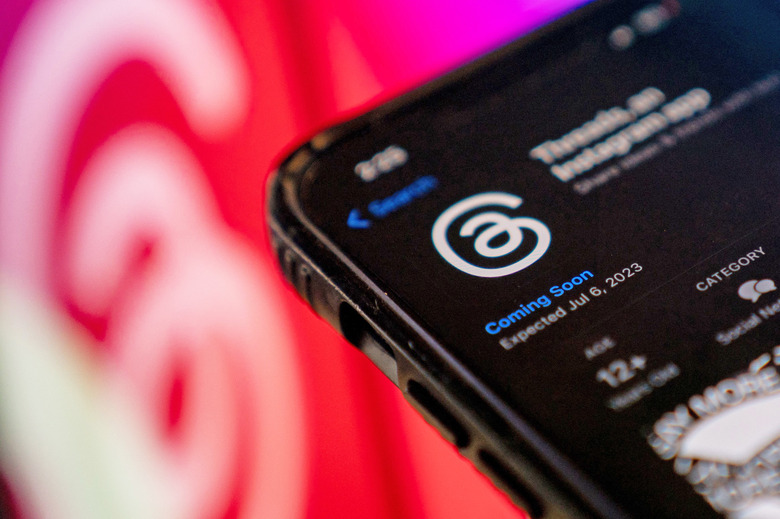 TOPSHOT - This photo illustration created in Washington, DC, on July 5, 2023, shows Threads, an Instagram app, on the App Store, in front of the logos of Instagram and Threads. Facebook owner Meta's new Threads app, meant to compete with Twitter, was available for pre-order on mobile app stores on iPhone and Android operating systems on July 5, 2023. Listed as 