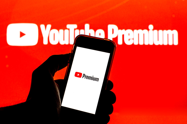 BARCELONA, CATALONIA, SPAIN - 2021/07/26: In this photo illustration a YouTube Premium logo seen displayed on a smartphone and in the background. (Photo Illustration by Thiago Prudêncio/SOPA Images/LightRocket via Getty Images)
