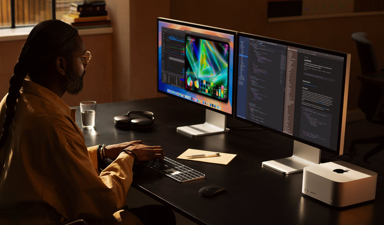 Someone using the Mac Studio paired with two displays.