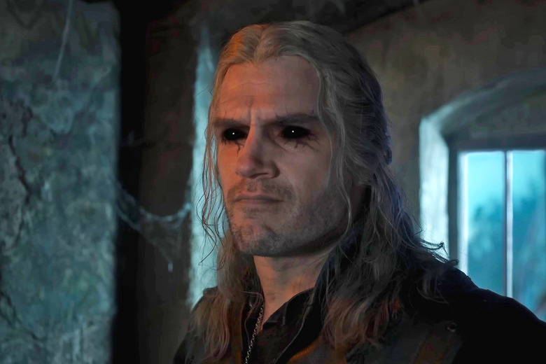 A close up of Henry Cavill as Geralt in 'The Witcher' season 3, showing him with dark black eyes and dark veins surrounding them.