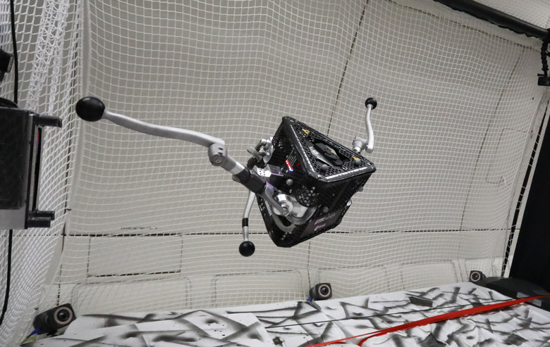 A robot with three legs suspended in mid-air.