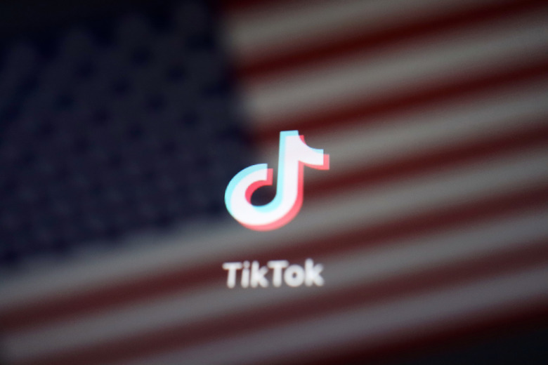 A reflection of the U.S. flag is seen on the sign of the TikTok app in this illustration picture taken September 19, 2020. REUTERS/Florence Lo/Illustration