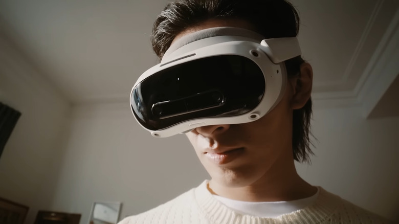 A person wearing a Pico 4 Ultra headset and looking off-camera.