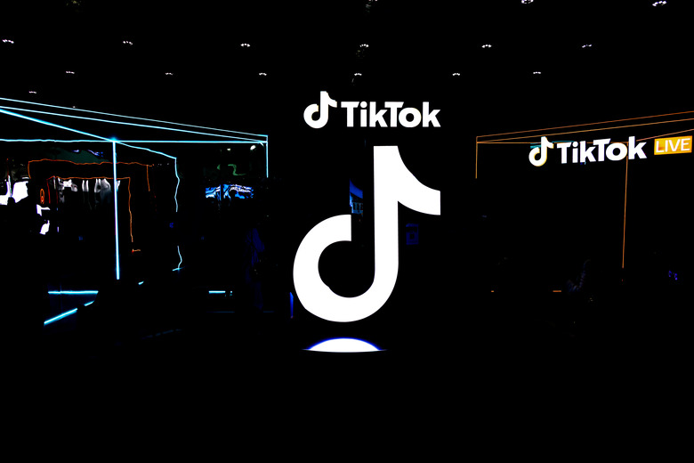 TikTok exhibition stand with the logo of the social media video platform illuminating while people attending.  (Photo by Nicolas Economou/NurPhoto via Getty Images)