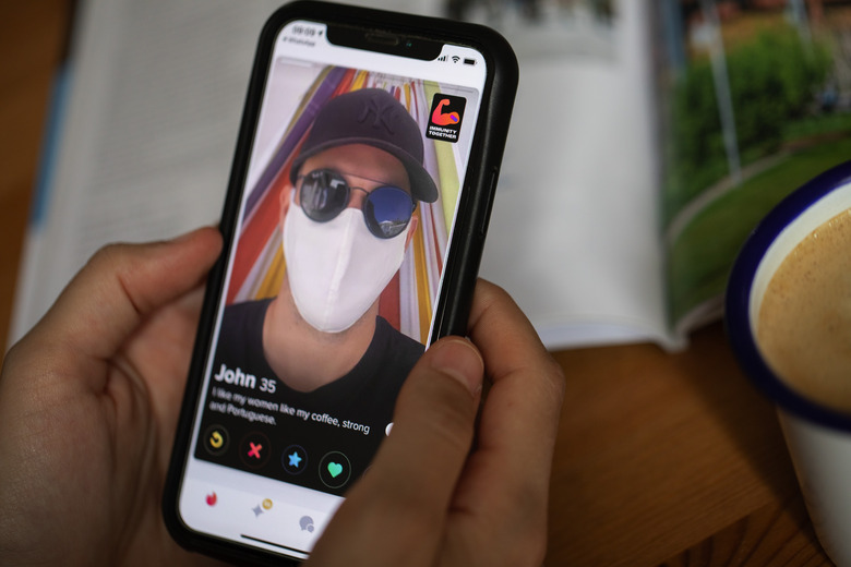 LONDON, ENGLAND - JUNE 11: In this photo illustration, A covid vaccine sticker is seen displayed on the photographer’s Tinder dating app profile on June 11, 2021 in London, England. In partnership with the UK government, Tinder, Match, Hinge, Bumble, Badoo, Plenty of Fish, OurTime and Muzmatch have all signed up to a scheme where UK online daters will be able to choose to display a badge on their profiles to show if they have been vaccinated against Covid or support the jab drive. (Photo Illustration by John Phillips/Getty Images)