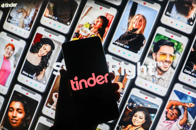 Tinder app logo is displayed on a mobile phone screen photographed on Tinder website background. Krakow, Poland on January 15, 2021. Numbers show that the Covid-19 pandemic resulted  in an increase in people looking for love online on dating apps and websites. (Photo illustration by Beata Zawrzel/NurPhoto via Getty Images)