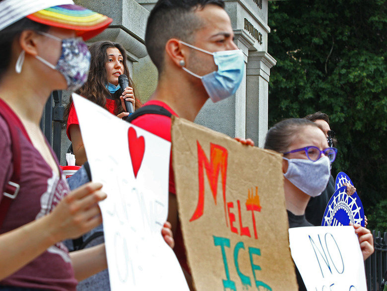 BOSTON, MA - JULY 13: Harvard senior Oya Gursoy, 22, addresses the crowd as Attorney General Maura Healey and international students rally at the State House against ICE visa rules that would potentially remove students from the country or prevent others reentry, weeks before fall semester begins, during the coronavirus pandemic on July 13, 2020 in Boston. (Photo by Pat Greenhouse/The Boston Globe via Getty Images)